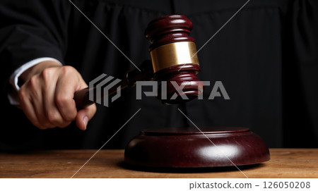 Judge delivering verdict with gavel in a courtroom setting Judge delivering verdict with gavel in a courtroom setting 126050208