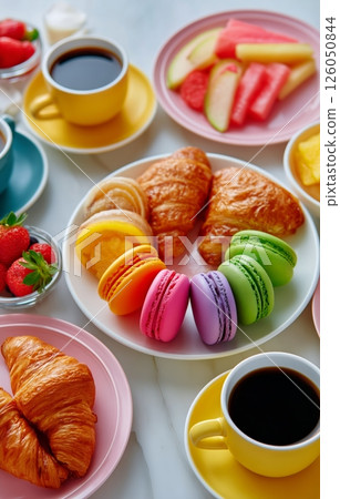 Colorful Breakfast Spread Featuring Croissants and Macarons With Fruits and Coffee 126050844