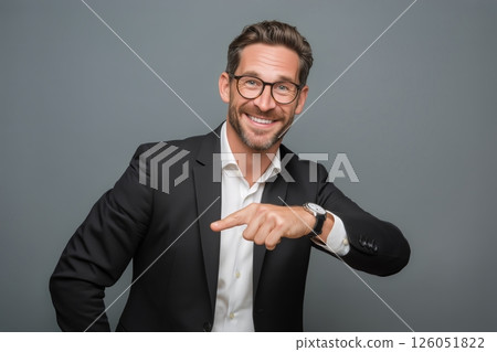 Confident Businessman Adjusting Cufflinks With a Smile in a Modern Office Setting 126051822