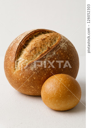 Freshly Baked Bread Loaf and Roll on a Plain Background in Natural Light 126052303