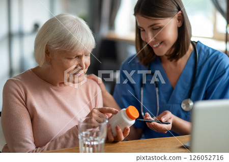Nurse explaining elderly woman patient medications in medical clinic or in hospice care Nurse explaining elderly woman patient medications in medical clinic or in hospice care 126052716