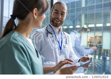 Doctors discussing an interesting case and looking involved Doctors discussing an interesting case and looking involved 126052828