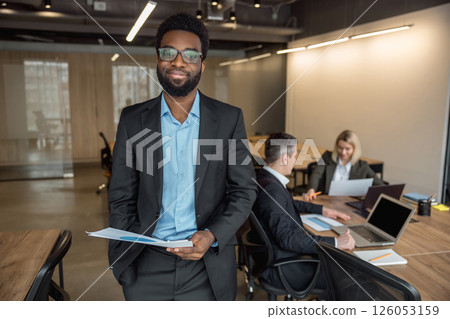 Elegant african american businessman in the office with his colleagues 126053159