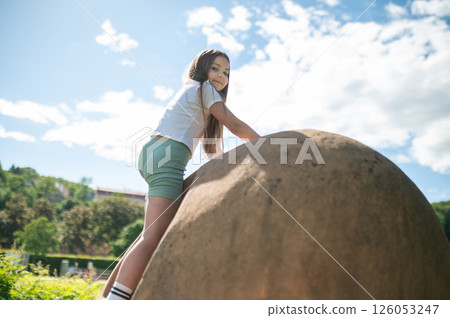 Young kid playing in park playground in nature during fun spring day 126053247