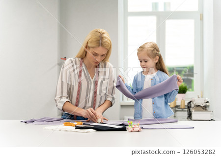 Blonde woman tailoring a new model in her design studio Blonde woman tailoring a new model in her design studio 126053282