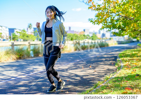 Cool woman jogging along the river Exercise Running Diet Walking Cool woman jogging along the river Exercise Running Diet Walking 126053367