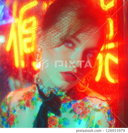 Fashion model posing under neon lights in urban setting 126053979