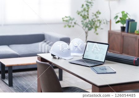 Helmet and laptop in the office (unmanned) 126054485