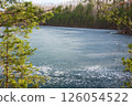Rocky Cliff Above Frozen Lake with Pine Trees in Early Spring 126054522