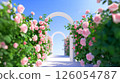 A walkway with an arch decorated with roses 126054787