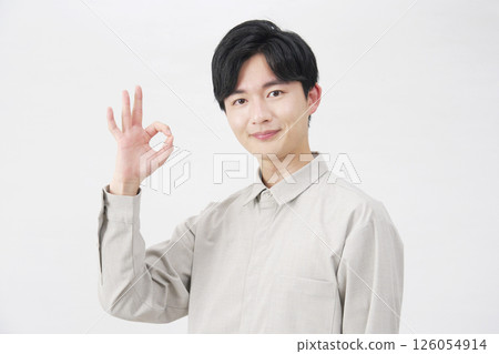 Man in his 20s OK sign white background 126054914