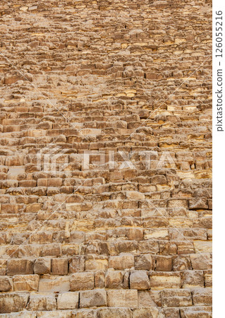 Historic stone facade of a pyramid showcasing ancient construction techniques in Egypt during the daytime Historic stone facade of a pyramid showcasing ancient construction techniques in Egypt during the daytime 126055216