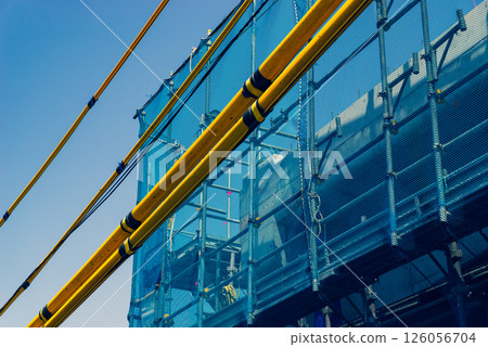Railway viaduct construction Scaffolding and electric wire protection pipes Around Higashimurayama Station, Tokyo 2025.04 d-3 Warm and cool colors 126056704