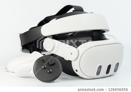 Modern VR headset and controller showcasing advanced technology on clean surface 126056856