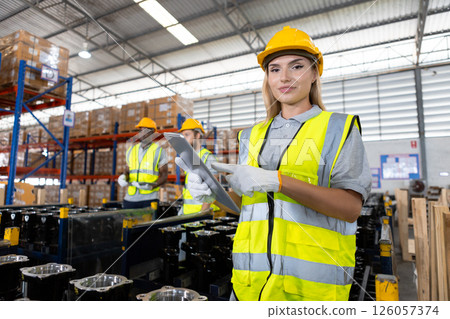 Portrait women worker holding tablet standing car parts in warehouse. Import-export shipping transportation, logistic business factory concept. Portrait women worker holding tablet standing car parts in warehouse. Import-export shipping transportation, logistic business factory concept. 126057374