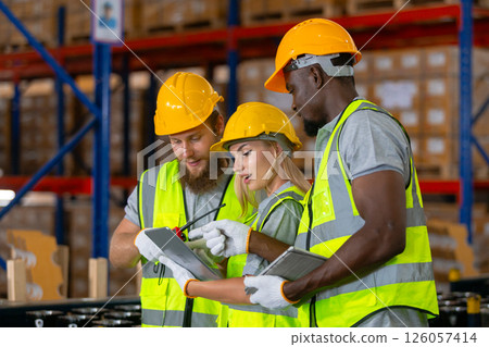Person professional worker wearing safety uniform using tablet inspect goods on shelves in warehouse. Workers checklist stock inspecting product in storage for logistic. Person professional worker wearing safety uniform using tablet inspect goods on shelves in warehouse. Workers checklist stock inspecting product in storage for logistic. 126057414