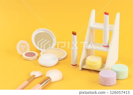 Cosmetics in pop colors lined up on a yellow background 126057415