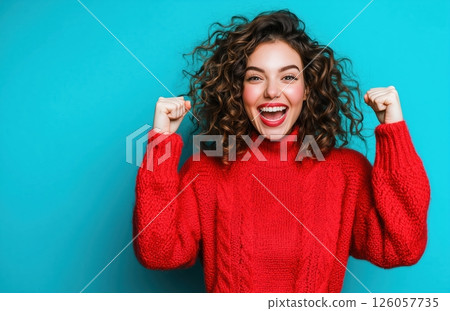 excited woman in a red sweater celebrating excited woman in a red sweater celebrating 126057735