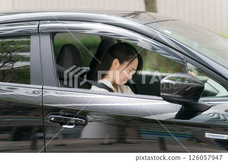 Young woman in a car Young woman in a car 126057947