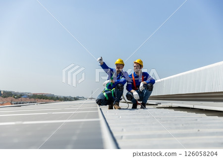 Man worker set installation and inspection standards of solar panels on roof of an industrial factory. Team technician inspection solar cell. Alternative innovation power environmental 126058204