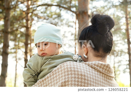 Woman Holding Her Baby Kid Outdoors on Sunny Day. Concept of Motherhood, Family Love and Childhood Bonding Experience. 126058221