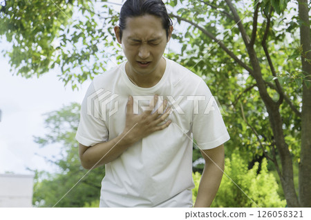 Young man holding his chest while running, heart attack, myocardial infarction 126058321