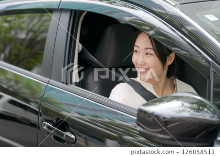 Young woman in a car Young woman in a car 126058511