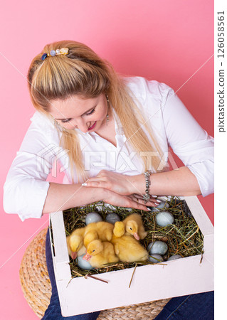 girl with cute duckling on color background girl with cute duckling on color background 126058561