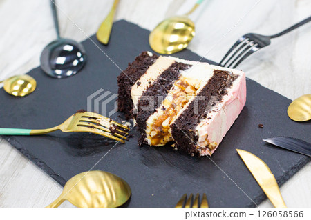 a piece of cake on a plate and a lot of spoons around a piece of cake on a plate and a lot of spoons around 126058566