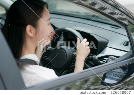 Young woman in a car Young woman in a car 126058907