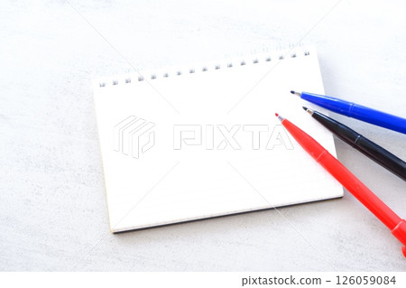 An image of doing desk work with a ring-type notepad and pen An image of doing desk work with a ring-type notepad and pen 126059084