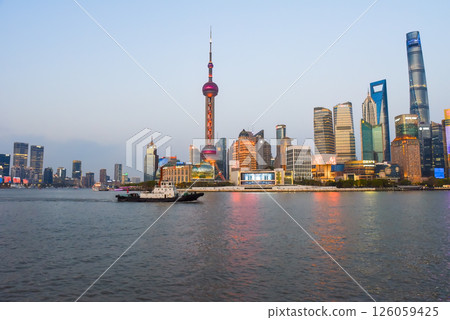 Shanghai, China - 1 April 2025: Tourist boat passes along the Bund waterfront in front of Pudong skyline featuring Oriental Pearl Tower and Shanghai Tower Shanghai, China - 1 April 2025: Tourist boat passes along the Bund waterfront in front of Pudong skyline featuring Oriental Pearl Tower and Shanghai Tower 126059425
