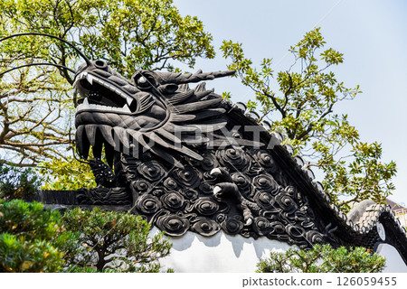 Shanghai, China - 1 April 2025: Dragon carving on the tiled roof of yuyuan garden, symbol of Chinese culture, harmony and classic garden design Shanghai, China - 1 April 2025: Dragon carving on the tiled roof of yuyuan garden, symbol of Chinese culture, harmony and classic garden design 126059455
