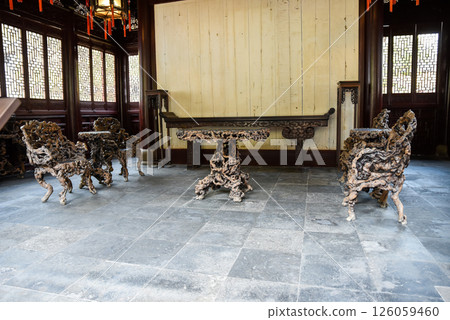 Shanghai, China - 1 April 2025: Banyan root chairs and furniture in He Xu Hall, located within the historic Dianchun Hall of Yuyuan Garden Shanghai, China - 1 April 2025: Banyan root chairs and furniture in He Xu Hall, located within the historic Dianchun Hall of Yuyuan Garden 126059460