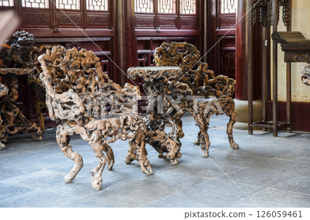 Shanghai, China - 1 April 2025: Interior view of He Xu Hall featuring sculptural chairs made from banyan roots in Dianchun Hall, Yuyuan Garden Shanghai, China - 1 April 2025: Interior view of He Xu Hall featuring sculptural chairs made from banyan roots in Dianchun Hall, Yuyuan Garden 126059461