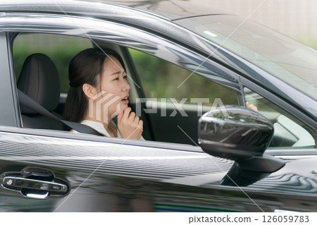 Young woman in a car Young woman in a car 126059783