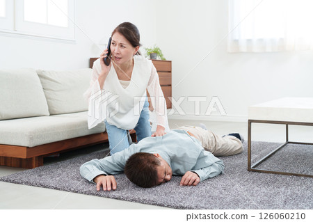 Senior woman calling an ambulance by phone 126060210