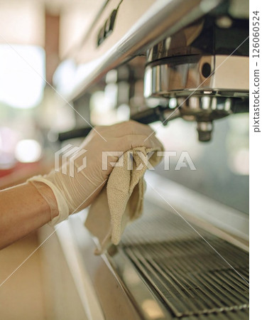 barman hand at beer tap pouring draught lager beer serving in a restaurant 126060524