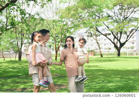 Happy family enjoying a sunny day in the park Happy family enjoying a sunny day in the park 126060601