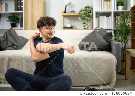 Young caucasian man preparing for a workout in a bright, modern room 126060657
