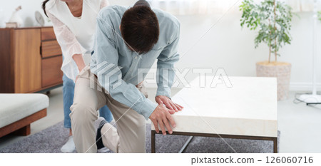 Senior man with back pain and senior woman supporting him 126060716