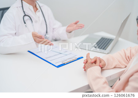 Doctor explaining diagnosis and treatment plan to elderly patient during hospital appointment. Senior patient talking doctor to disease. medical consulting, geriatric care, healthcare concept 126061676