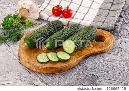 Raw green cucumbers with slices 126062416