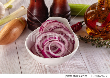 Sliced red onion rings heap 126062827