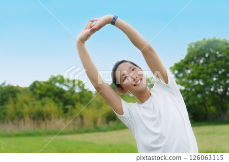 Young man stretching in the park Young man stretching in the park 126063115