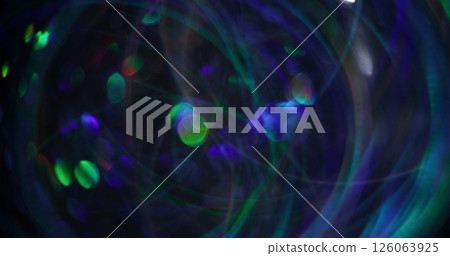 Bokeh light. Blurred color glow. Green blue lens flare swirling on modern shiny abstract dark black background. Bokeh light. Blurred color glow. Green blue lens flare swirling on modern shiny abstract dark black background. 126063925