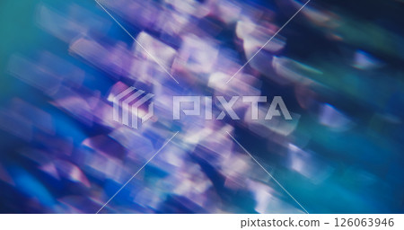 Light swirling. Defocused shine particles. White sparkle lens flare turning on blue purple optical blurred smoky bokeh background. Light swirling. Defocused shine particles. White sparkle lens flare turning on blue purple optical blurred smoky bokeh background. 126063946