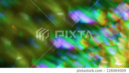 Defocused kaleidoscope flare. Crystal texture. Multicolor green purple yellow lens light reflection on abstract art blurred background. Defocused kaleidoscope flare. Crystal texture. Multicolor green purple yellow lens light reflection on abstract art blurred background. 126064009