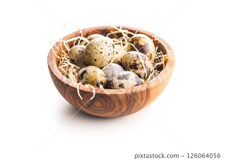 Spotted quail eggs in bowl isolated on white background. Spotted quail eggs in bowl isolated on white background. 126064056