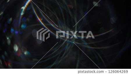 Defocused light flare. Night radiance. Rainbow multicolor illuminated festive blue lens on abstract bokeh blurred background. Defocused light flare. Night radiance. Rainbow multicolor illuminated festive blue lens on abstract bokeh blurred background. 126064269